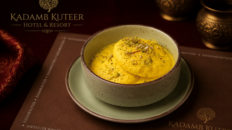 Saffron kheer served in a white bowl on a branded placemat at Kadamb Kuteer, Vrindavan.