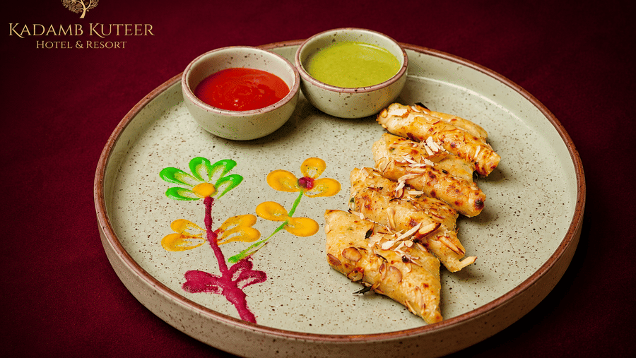 Plated tikka starter with chutneys and garnish on a floral-decorated plate at Kadamb Kuteer, Vrindavan.