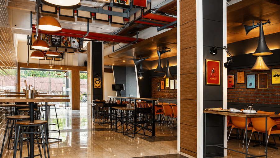 Dining area with comfortable seating at the restaurant of Max Hotel Jabalpur.