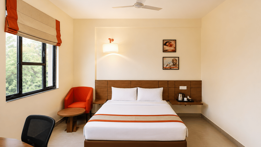 Well appointed guest room with a queen bed at Max Hotel Jabalpur.