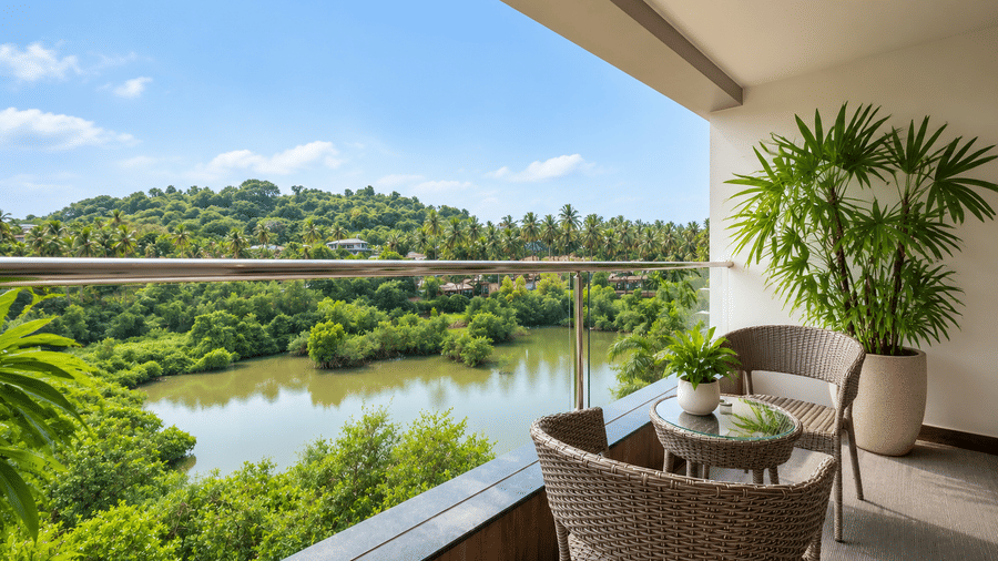 A private balcony featuring seating overlooking lush greenery at BluSalzz Collection - Casa Onze, Arpora.