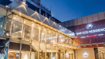 Facade view of the hotel against the night sky.