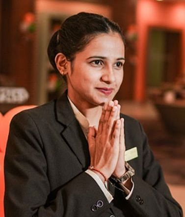 A woman greeting at Nirvana Luxury Hotel, Ludhiana.