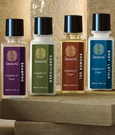 Four different bottles of skincare products placed on a surface at Nirvana Luxury Hotel, Ludhiana.