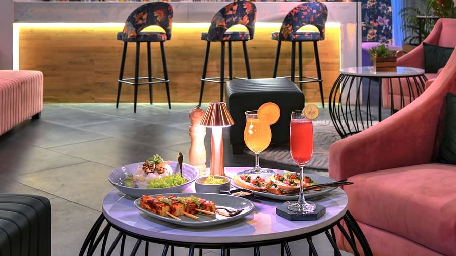 An image of delicious food and beverages placed on a coffee table at Panora Bar - Rooftop in Agra - Golden Tulip, Agra