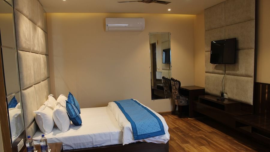 Mastiff Hotel in Dalhousie presents a side perspective of a room featuring a comfortable, luxurious bed - Mastiff Hotel, Dalhousie