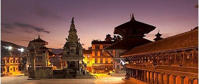An overview of Bhaktapur Durbar Square in the night with the lights on during the twilight sky