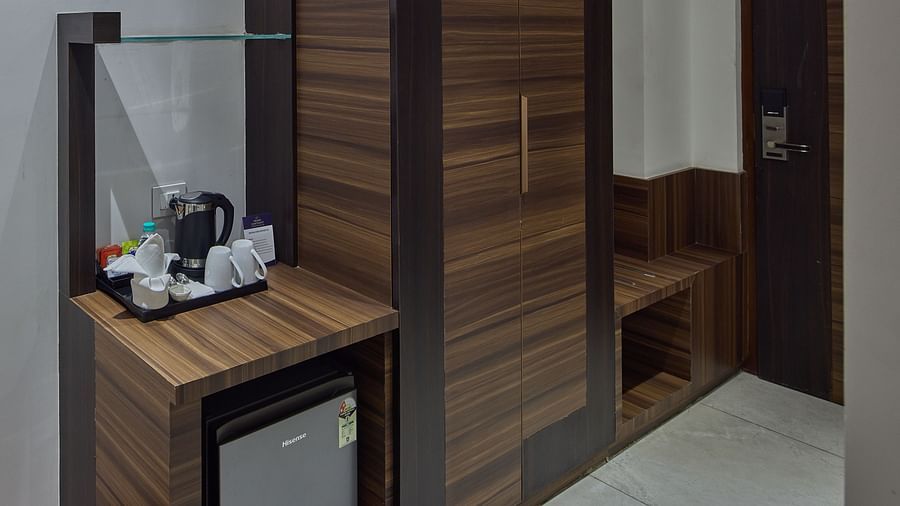 Wardrobe, fridge, tea and coffee maker in the suite at Grand Continent - A Sarovar Premiere Affiliate Hotel, Hosur