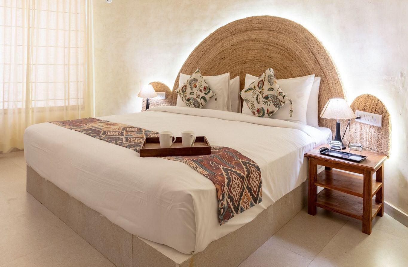 A room with a bed and a side table beside it at Valley by Grassfield.