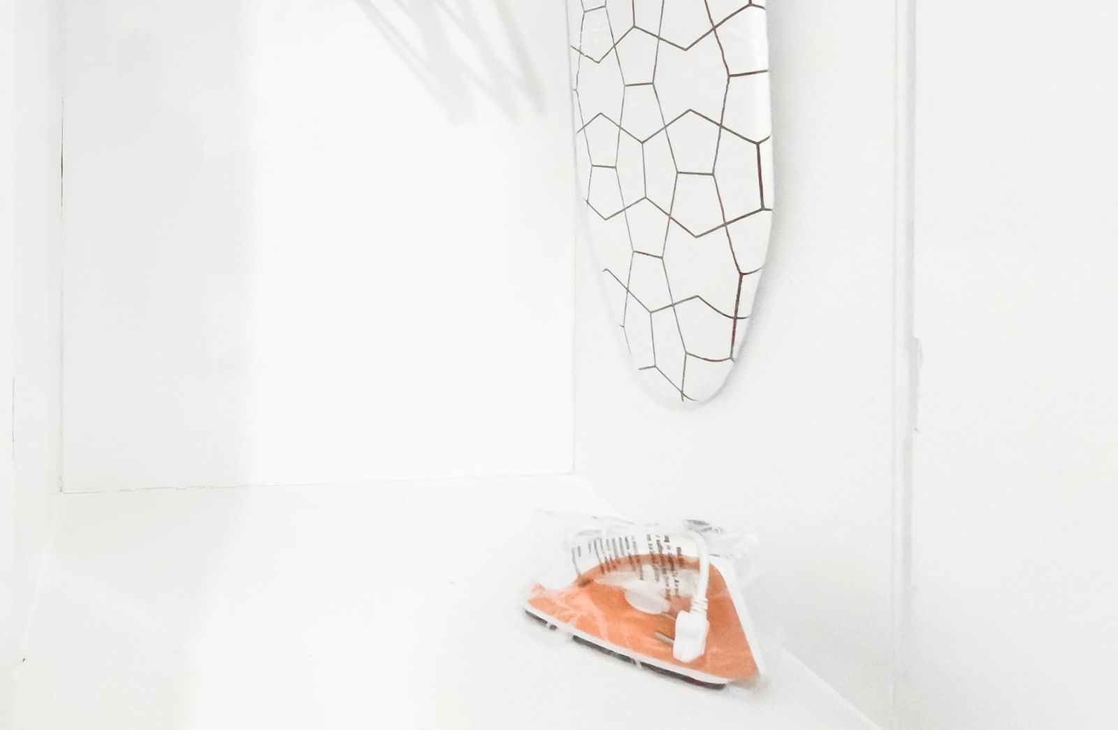 Open wardrobe with hangers and iron placed on the shelf at The Pinnacle, Electronic City.