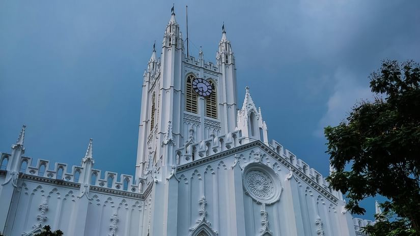 White church exterior under a cloudy sky.