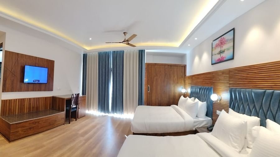 A view through the sofa of a two large beds in Family Suite Room at DLS Ark Holiday Inn, Banikhet.