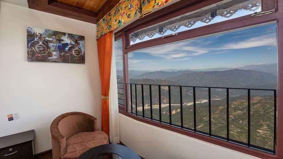 Image of a sitting area with view of the lush mountians at Summit Sherpa Mountain Hotel & Spa, Kalimpong