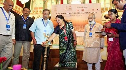 Group of people lighting a ceremonial lamp at a convention event