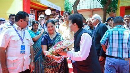 A woman receiving a large bouquet of flowers outdoors