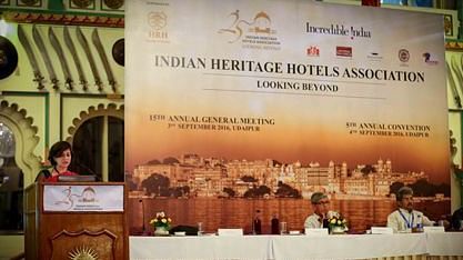 A woman speaking at a podium during the 5th Annual Convention of the Indian Heritage Hotels Association