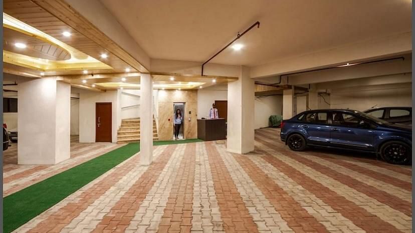 Image of an expansive parking space with some cars parked around | DLS La Serene Manali