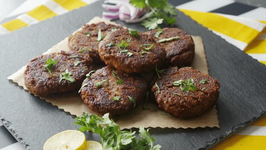Top angle view of delicious Mutton Galawat garnished with fresh coriander.