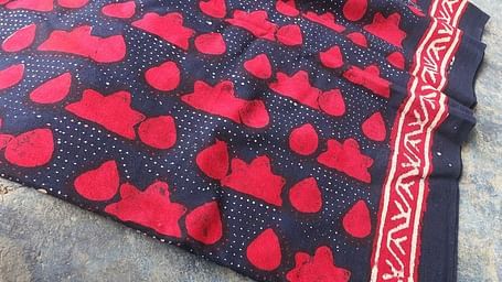 A piece of patterned fabric with a decorative border is shown.