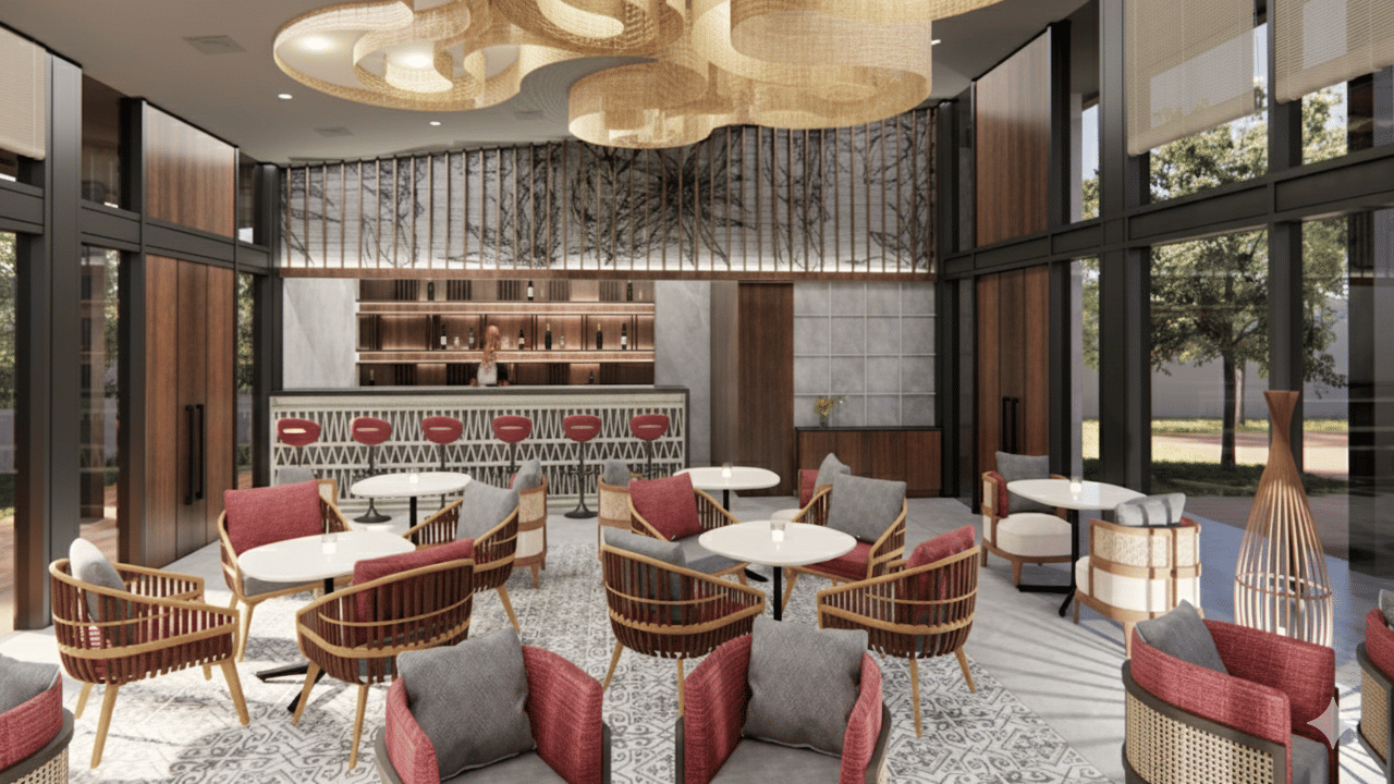 Render of a bar area at Vandhara Sarovar Premiere, Patkote, with patterned armchairs, small round tables, and large decorative circular ceiling fixtures.