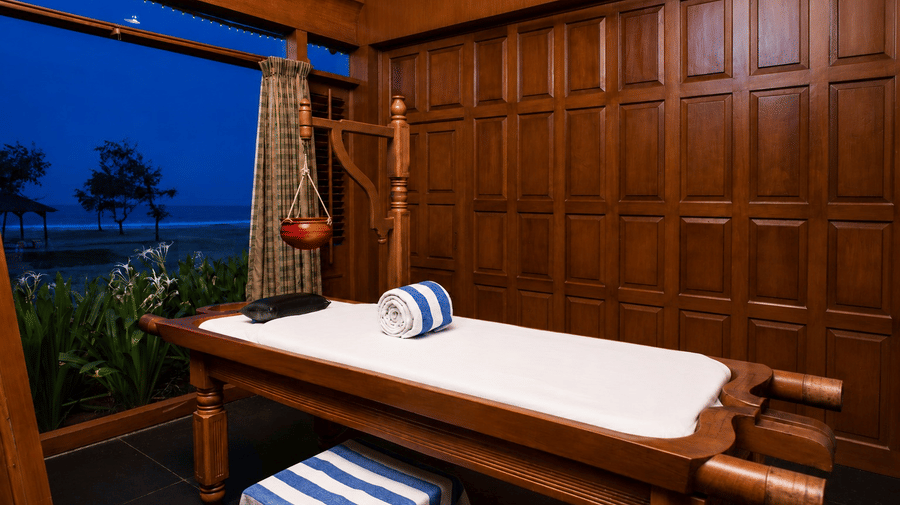Spa massage room with wooden interiors and a serene lake view at Chariot Beach Resort, offering a peaceful and rejuvenating experience.