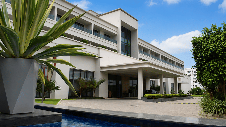 Exterior view of the main entrance and front driveway during daytime at Kiranshree Grand Hotel.