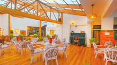 Sunset Bar and Lounge at Central Heritage Resort and Spa at the Mall Road, Darjeeling featuring several sets of table and chairs