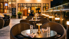 Elegant outdoor dining area with warm lighting at Pride Ashiyana Resort Mussoorie.