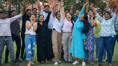 Corporate team celebrating during a company outing at MGM Beach Resorts, Chennai.