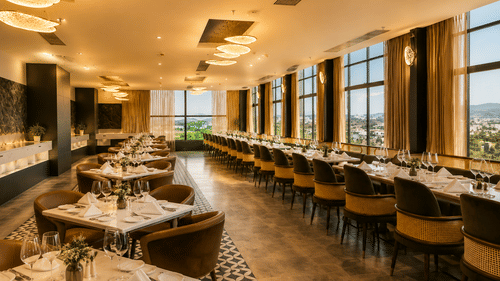 Square dining tables, a long banquette table setup, and large windows overlook trees under a lit ceiling at Pride Plaza Indore.