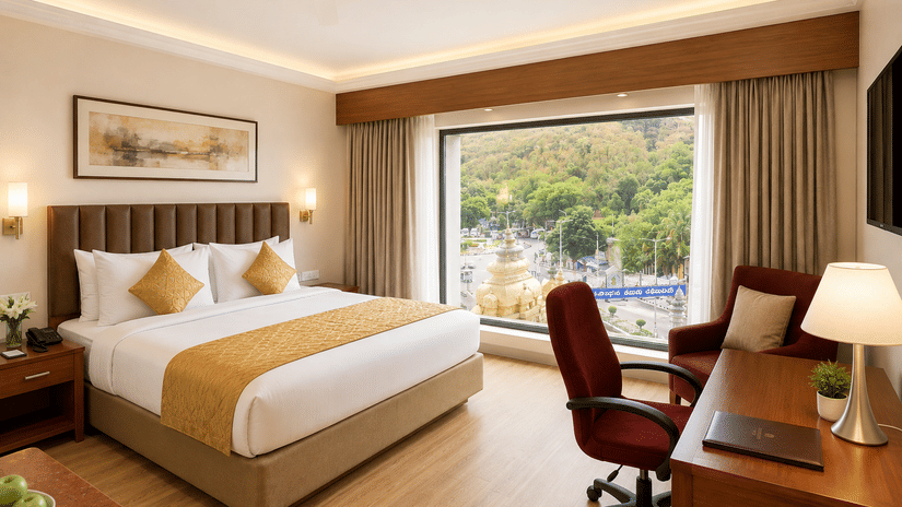 Superior Room at Raj Park Hotel in Tirupati featuring a plush bed facing the TV on the wall with a work desk below it next to a large floor-to-ceiling window