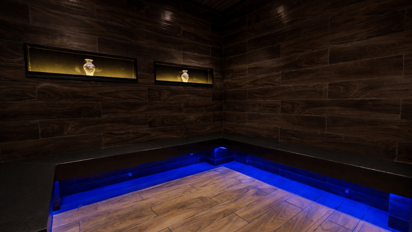 A room with wooden paneling and blue LED floor lighting  - Manor Sports & Wellness Hotel