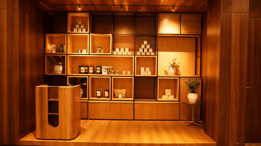 A wall unit featuring shelving filled with decorative items and products | Pride Premier Darjeeling