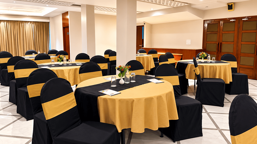 Sapphire Banquet Hall at Silver Sand Sentinel, Port Blair, featuring round tables with table settings, floral centrepieces, and banquet seating.