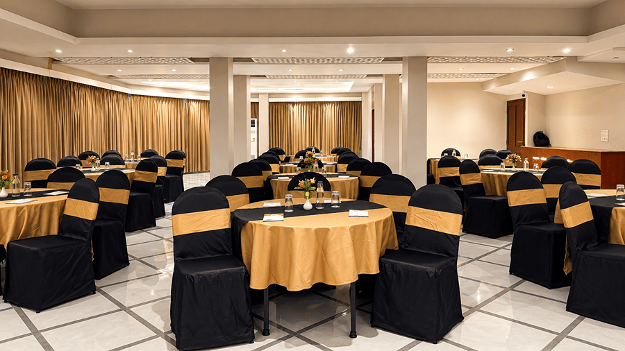 Sapphire Banquet Hall at Silver Sand Sentinel, Port Blair, showcasing multiple round tables with table settings, floral centrepieces, and arranged banquet seating.