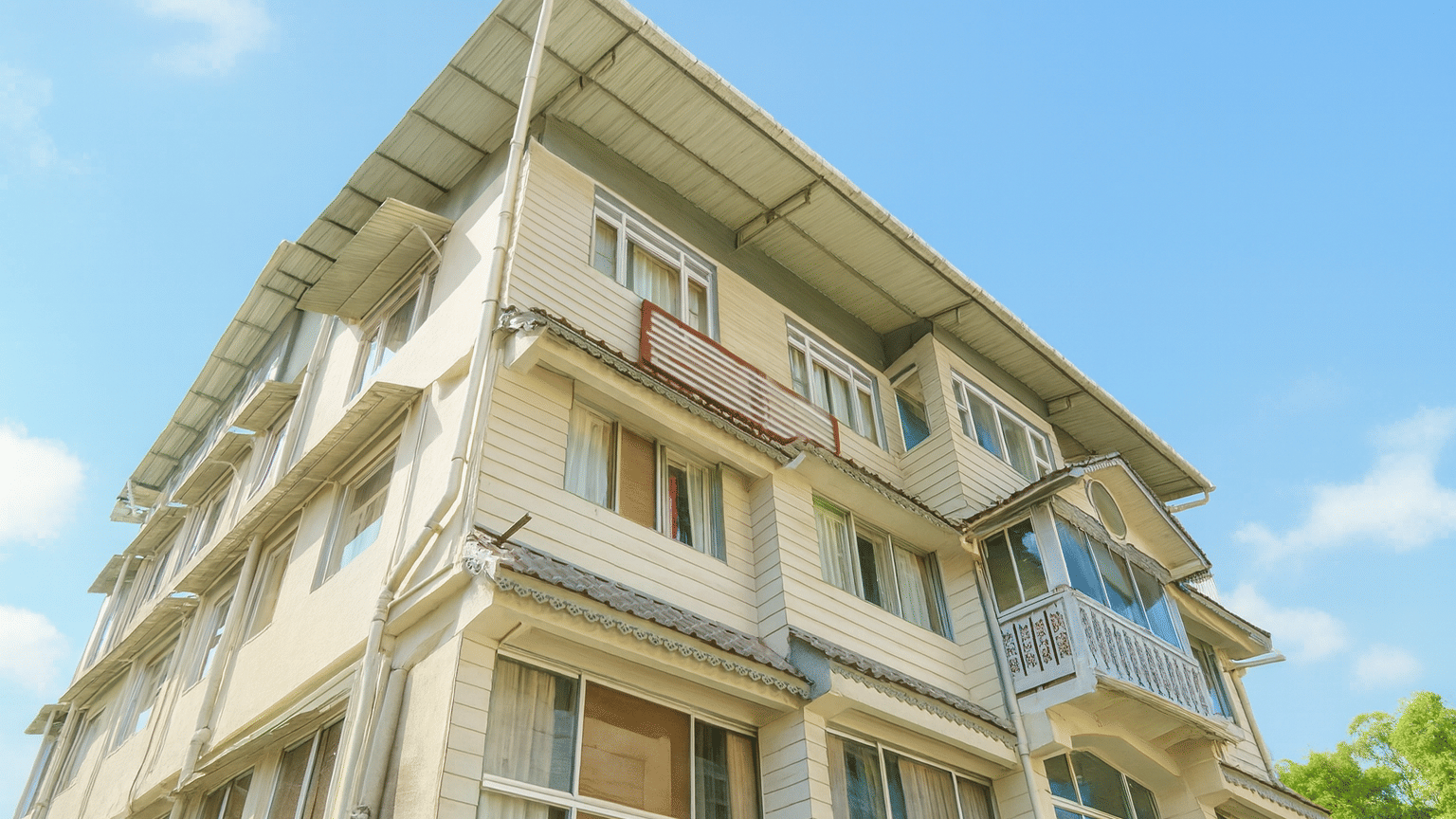 Avianna Seven Seas Hotel in Darjeeling captured in 4K quality during a sunny day, showcasing its elegant facade, clean architecture, and premium exterior lighting under a bright blue sky.