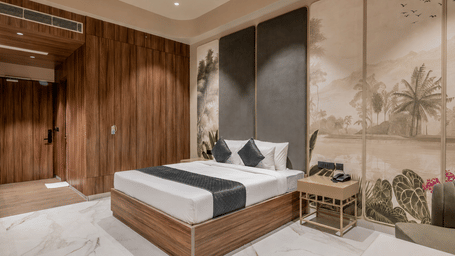Modern bedroom with a double bed, wooden wall panels, television, and bedside tables.