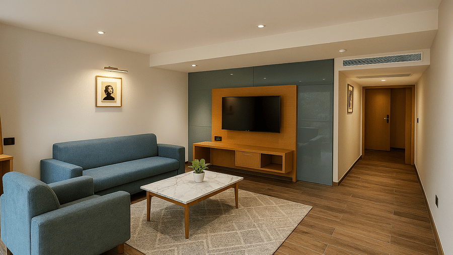 Executive Suite's living room area with sofas, a coffee table, and a wall-mounted TV at BluSalzz Collection - Casa Onze, Arpora.