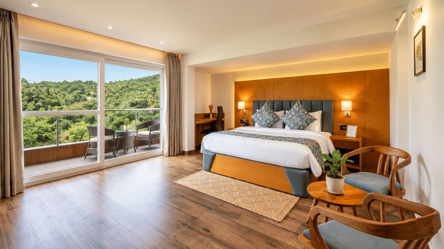 An airy bedroom suite with wooden flooring and balcony views at BluSalzz Collection - Casa Onze, Arpora.