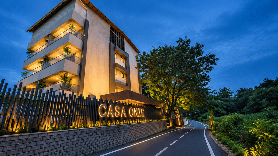 An exterior dusk view of the illuminated BluSalzz Collection - Casa Onze, Arpora along the road.