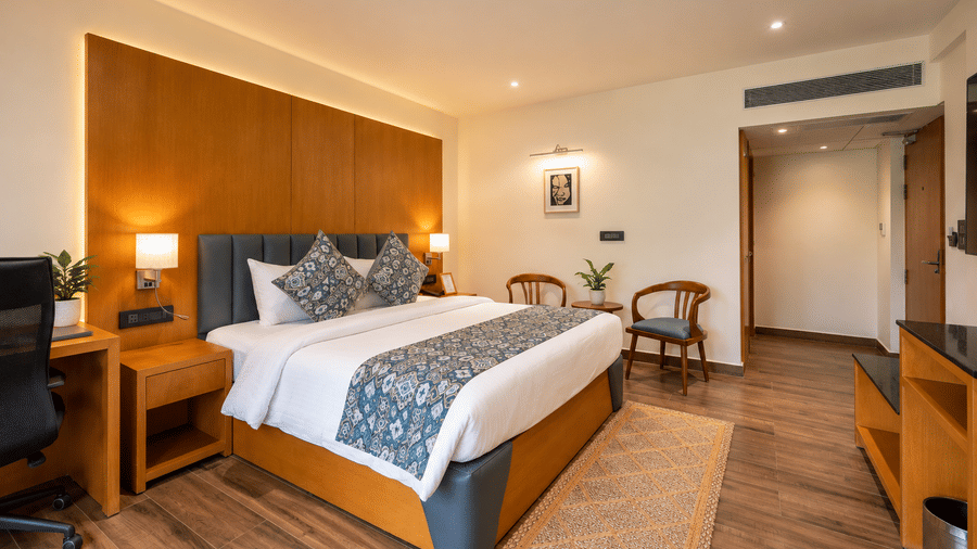 A spacious double bedroom featuring a study desk and seating at BluSalzz Collection - Casa Onze, Arpora.
