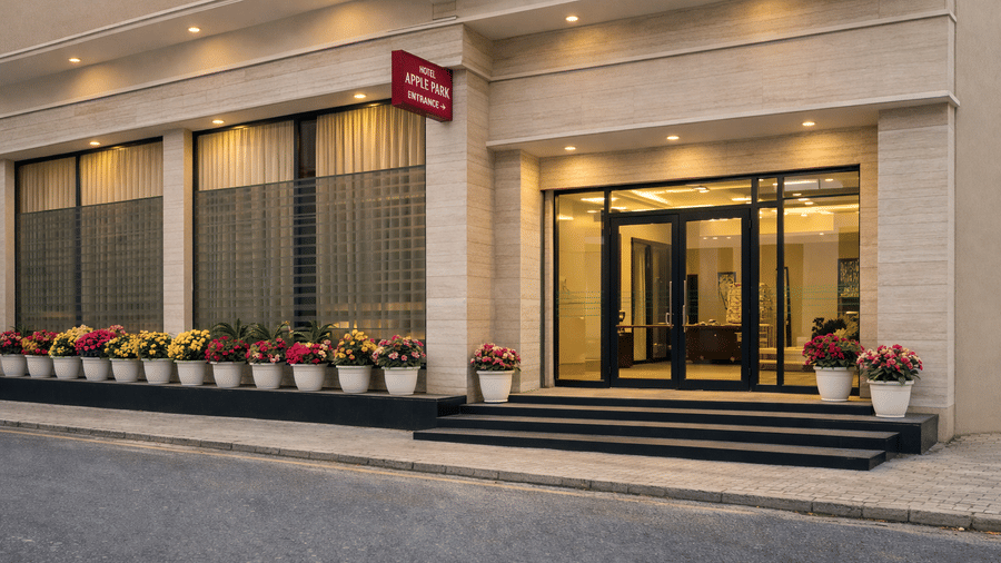 Glass front doors of building with hotel name and security personnel