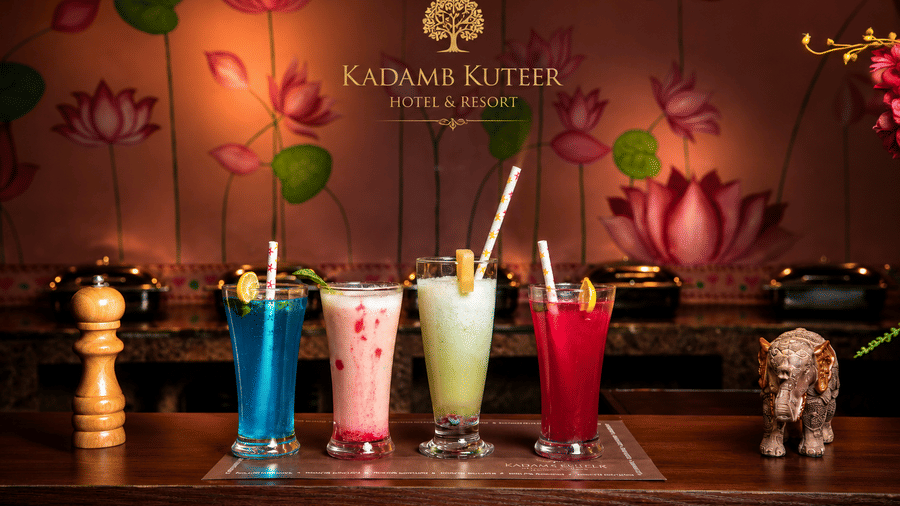 Assorted colourful mocktails in blue, pink, and green served together at Kadamb Kuteer, Vrindavan.