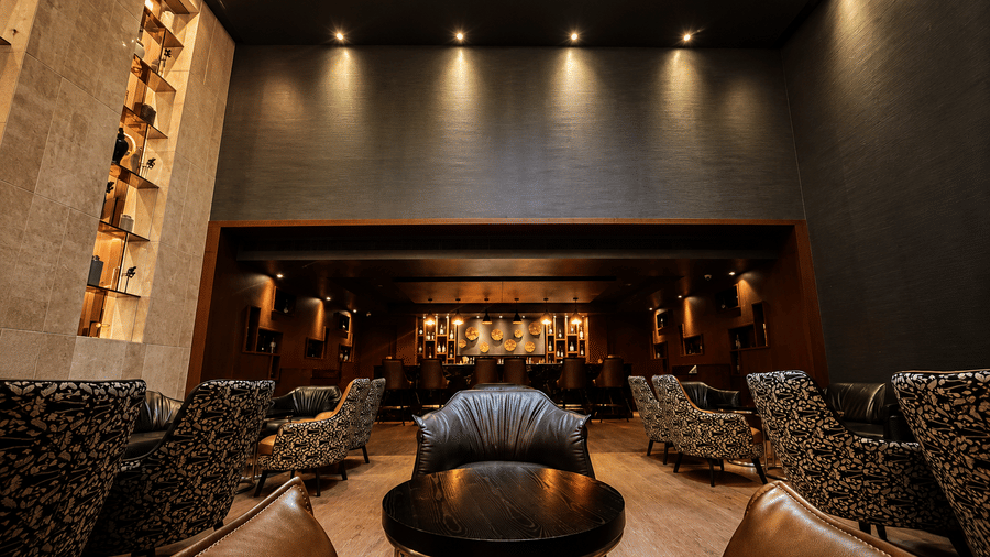 Stylish bar lounge with comfortable seating and warm mood lighting at Kiranshree Grand Hotel.