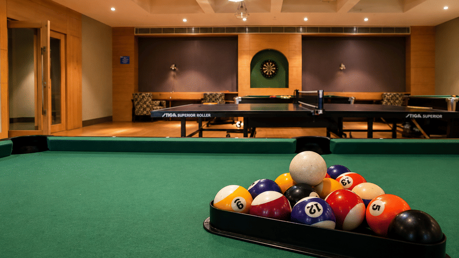 Close-up of pool balls rack on a green billiard table in the games room at Kiranshree Grand Hotel.