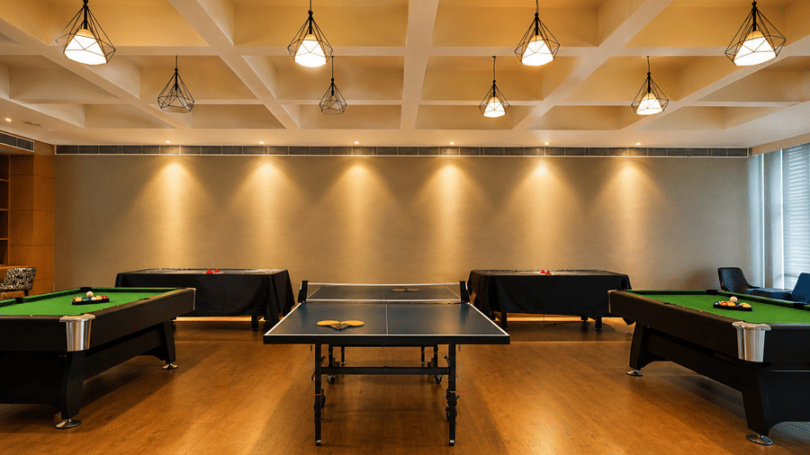 Indoor games room featuring billiard tables and a table tennis table at Kiranshree Grand Hotel.