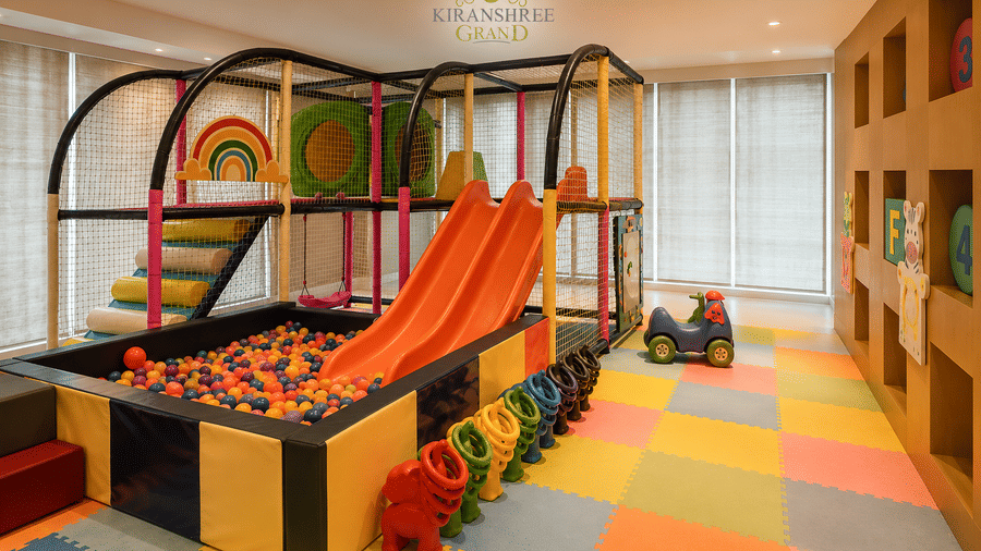 Colourful indoor play area for kids featuring a slide and ball pit at Kiranshree Grand Hotel.
