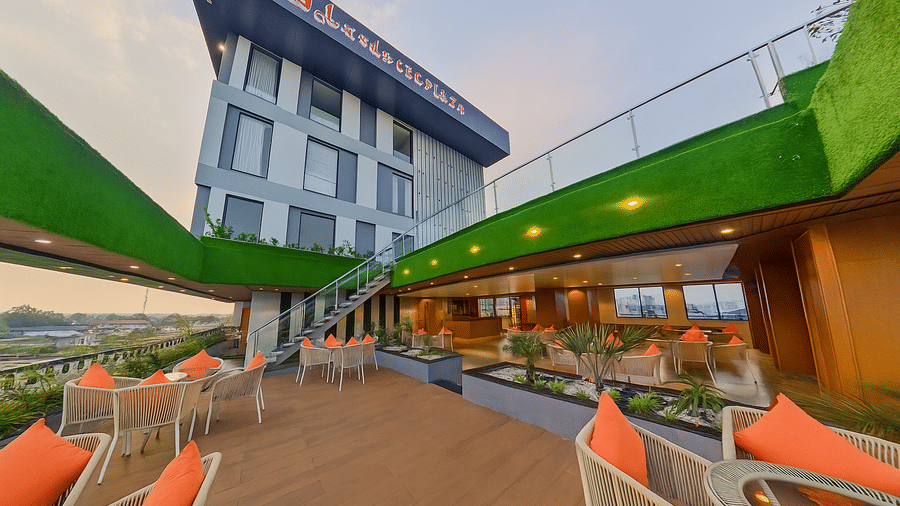 The outdoor lounge area for the bar featuring multiple chairs and the facade | Lords CBC Plaza