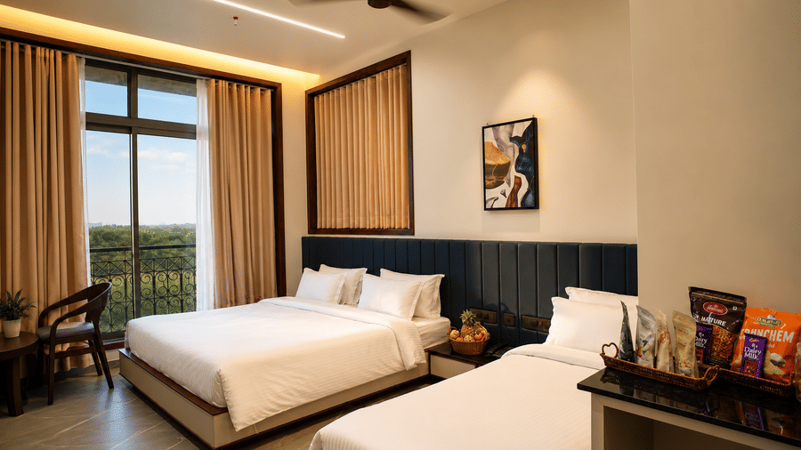 Family Room at Lords Swastik Studio, Kodinar featuring one king bed, one single bed, large windows, and contemporary furnishings.