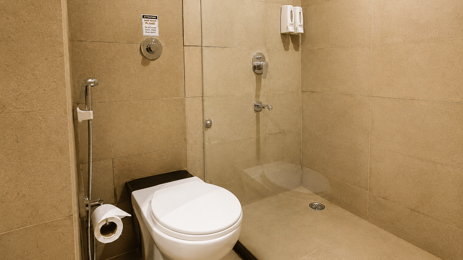 Well maintained bathroom with a walk in shower and modern fittings at Max Hotel Jabalpur.